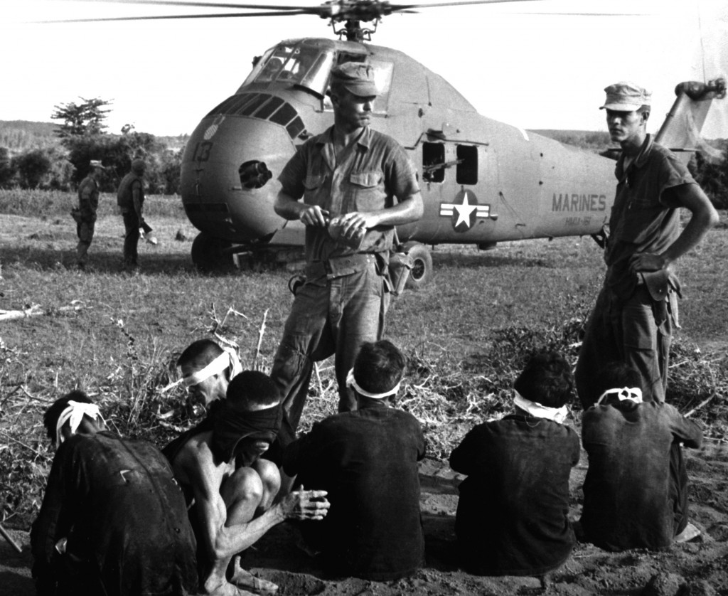 Operation Starlight, a U.S. Marine Corps search and destroy operation south of Chu Lai. VC casualties stood at 599 killed and six captured. Viet Cong prisoners await being carried by helicopter to rear area. August 1965. JUSPAO. (USIA) EXACT DATE SHOT UNKNOWN NARA FILE #: 306-MVP-21-2 WAR & CONFLICT BOOK #: 415