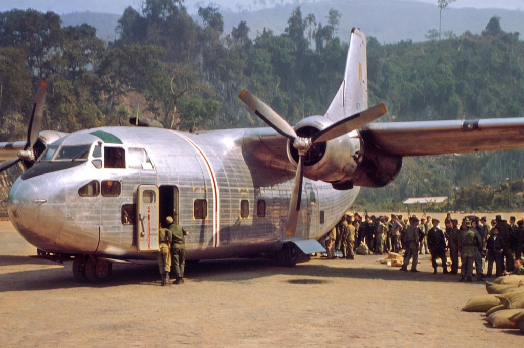 An-Air-America-C-123-delivering-supplies-and-picking-up-Laotian-troops-at-Long-Tieng.-RLW
